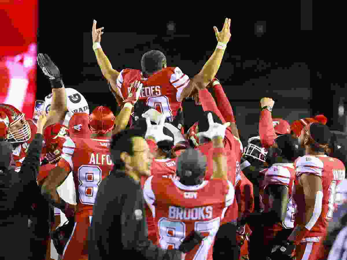 Calgary Stampeders kicker René Paredes is lifted up by his team after kicking the game winning field goal against