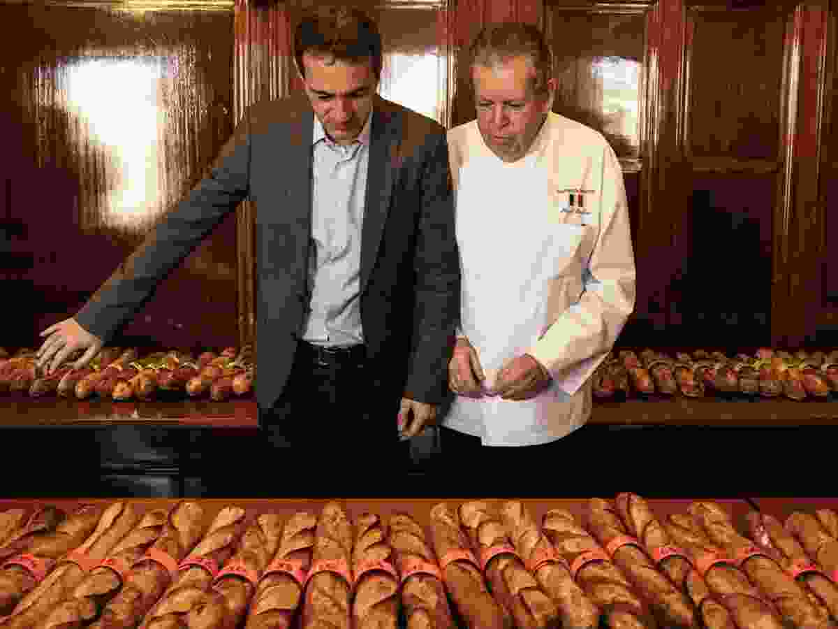 Nicolas Bonnet-Oulaldj, left, and Pascal Barillon, vice president of the Greater Paris Bakers and Pastry Chefs Union, inspect the bounty of baguettes.