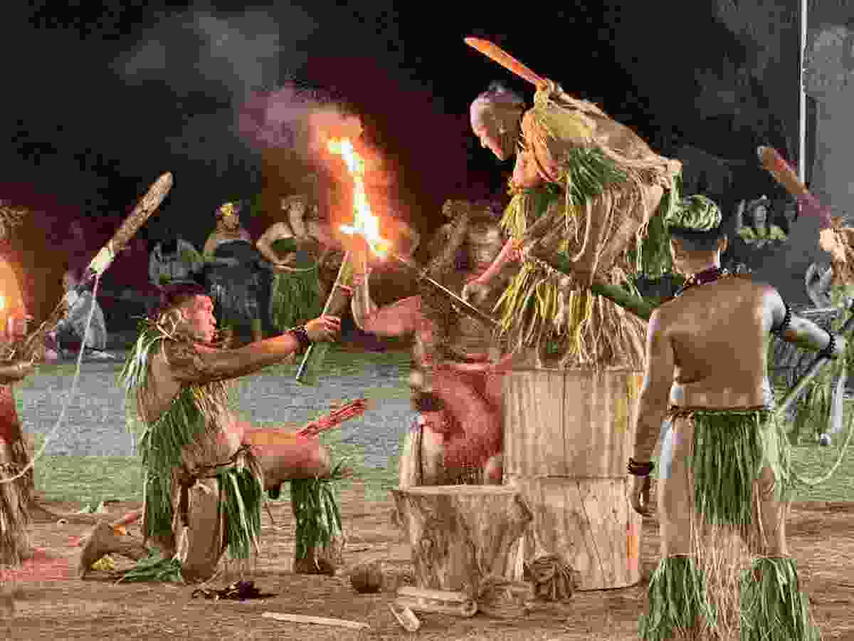 Male dancers from the island of Nuku Hiva perform the dance of fire.