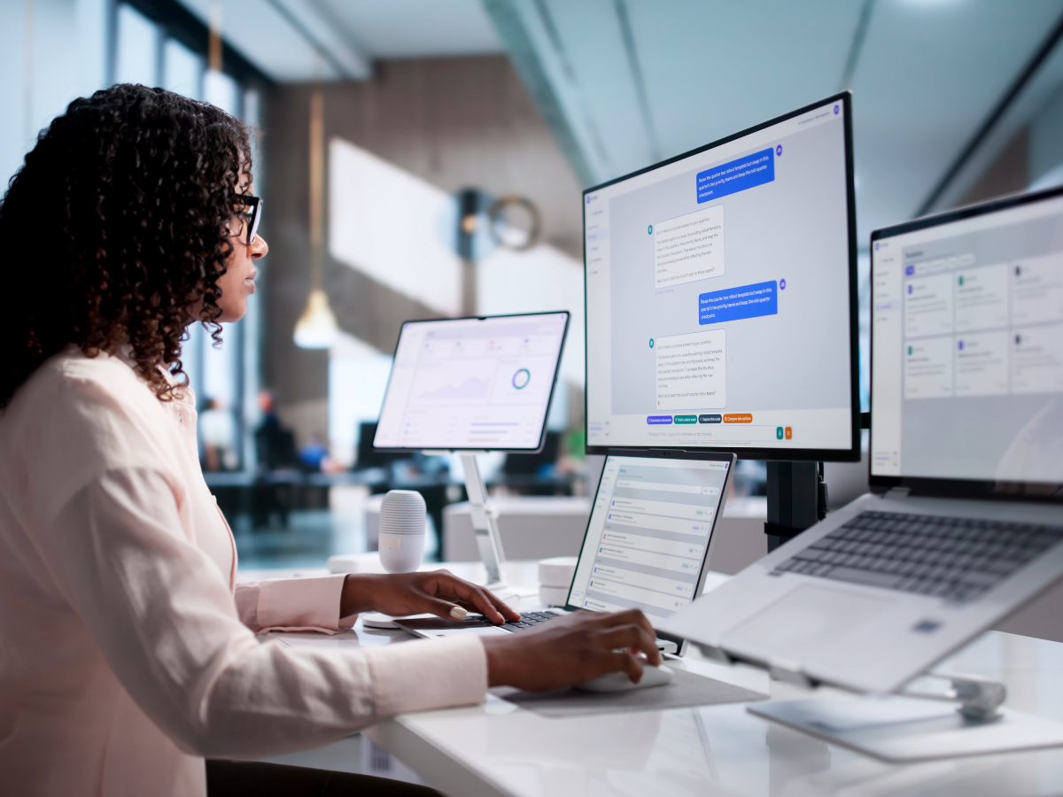 Young African American Woman Working On Laptop And Desktop