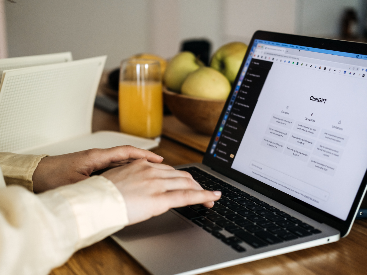 ChatGPT for content creators, ChatGPT help generate ideas and create content. Screen with ChatGPT AI or artificial intelligence chat and typing female hands.