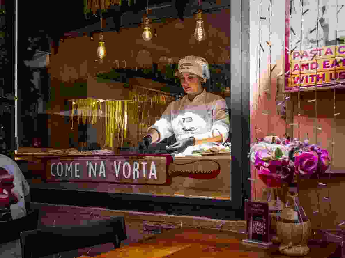 A pasta-maker works in the window of the Rome restaurant Come 'Na Vorta, in April.