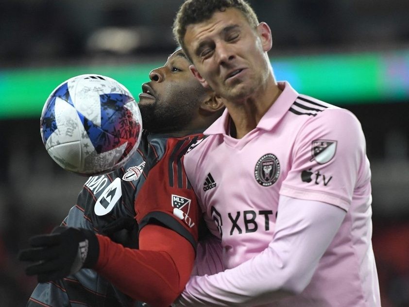 Mar 18, 2023; Toronto, Ontario, CAN; Toronto FC forward Ayo Akinola (20, left) battles for the ball with Inter Miami defender Christopher McVey(4) in the second half at BMO Field.