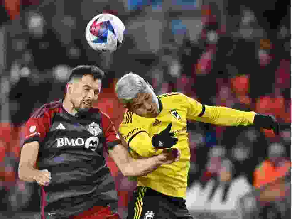 Mar 11, 2023; Toronto, Ontario, CAN; Toronto FC defender Matt Hedges battles for a header against Columbus Crew forward Cucho Hernandez in the second half in a MLS game at BMO Field.