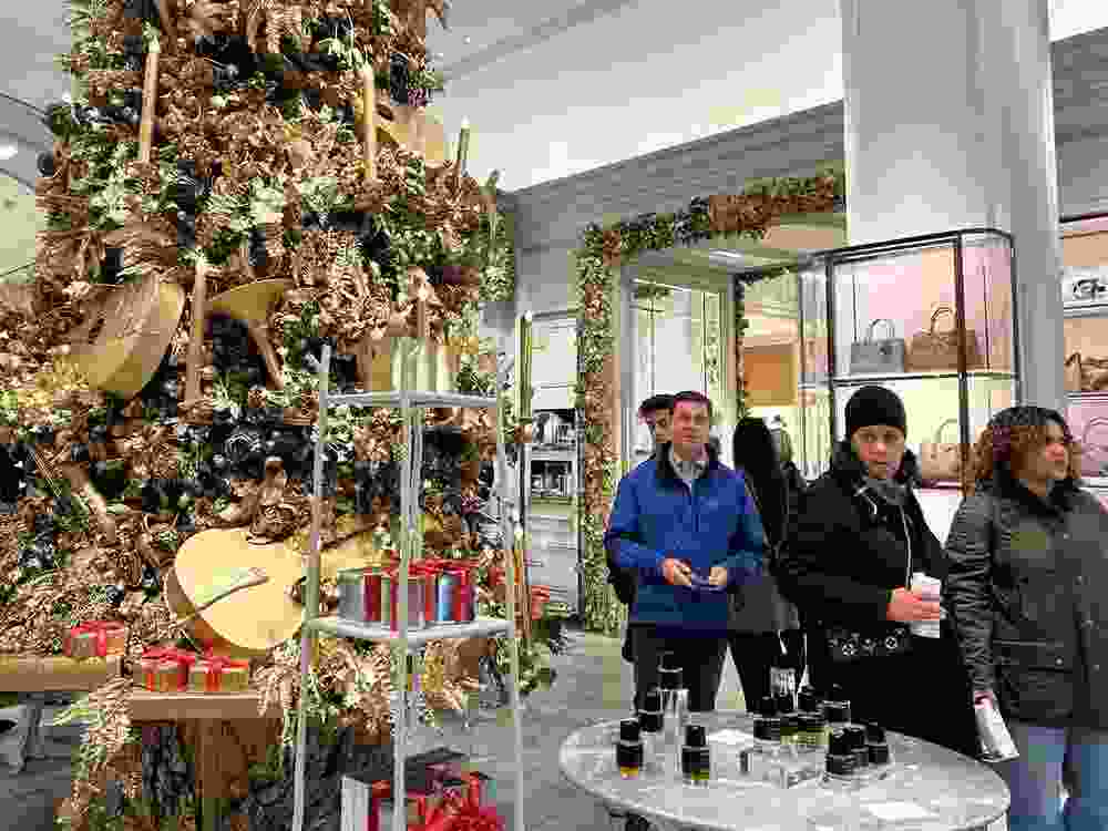 Shoppers pass a Christmas tree at the Bergdorf Goodman store on Sunday, Nov. 24, 2024, in New York.