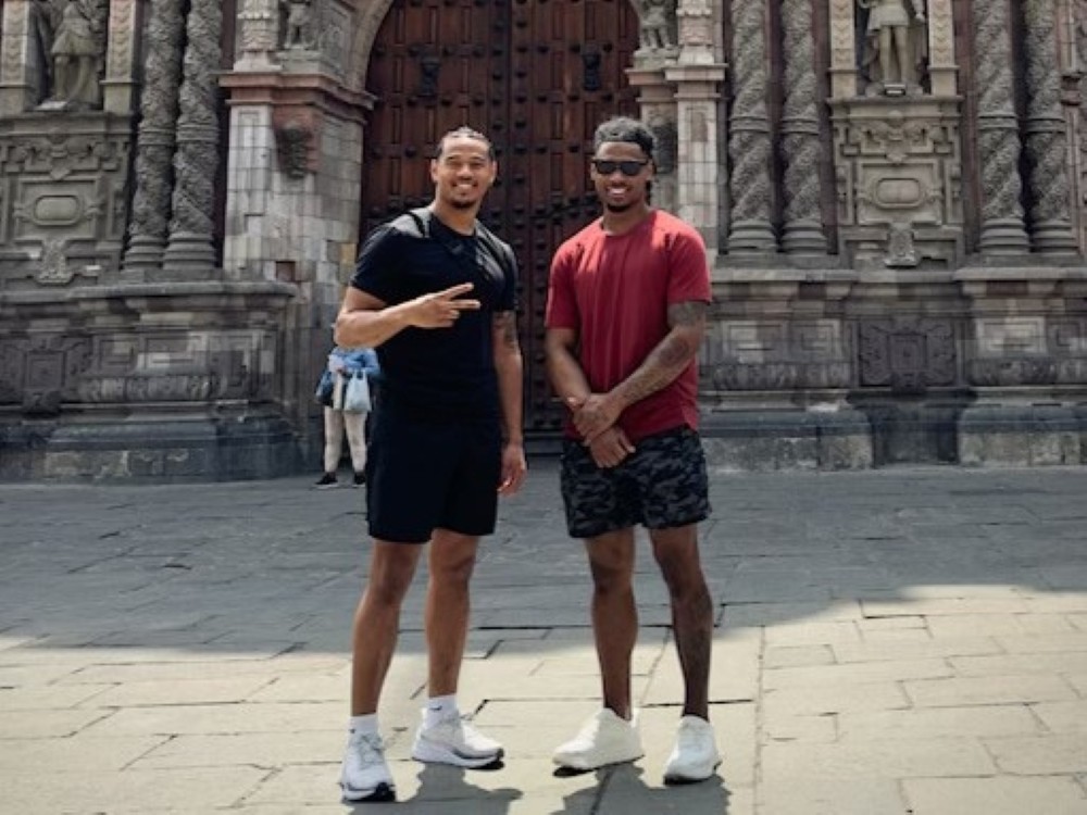 Brothers John and Royce Metchie pose for a photo.