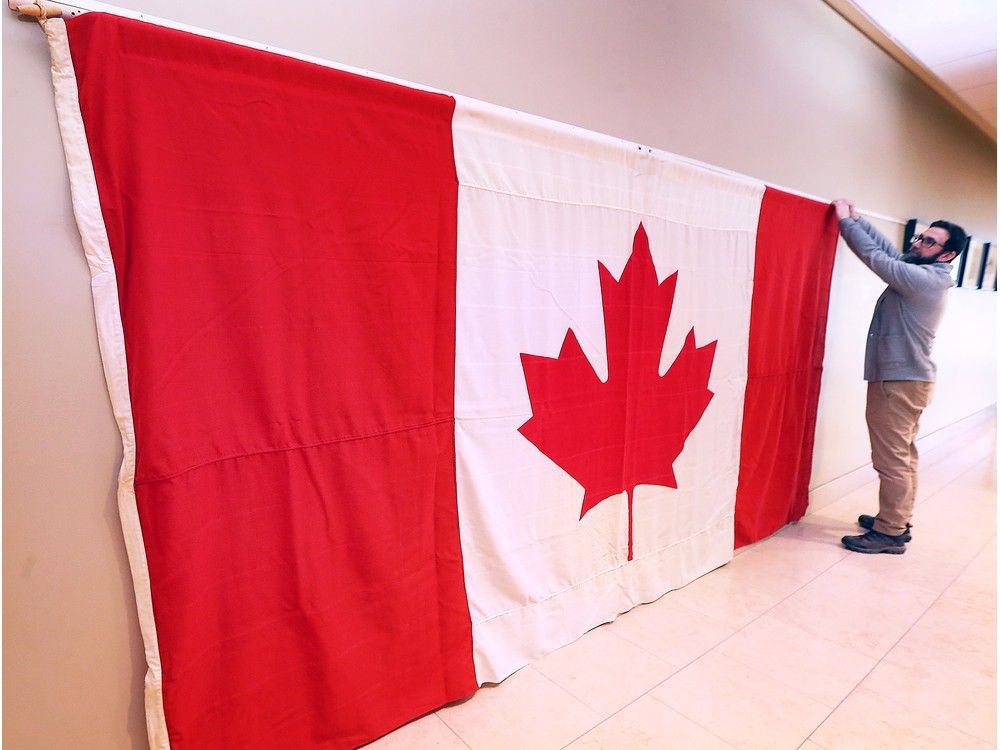 O Canada! To celebrate Saturday's 60th anniversary of the Canadian flag, Museum Windsor is displaying one of the original maple leafs raised on Parliament Hill on Feb. 15, 1965. Craig Capacchione, museum coordinator, sets up the flag on Tuesday, February 11, 2025. Museum admission on Saturday is free.