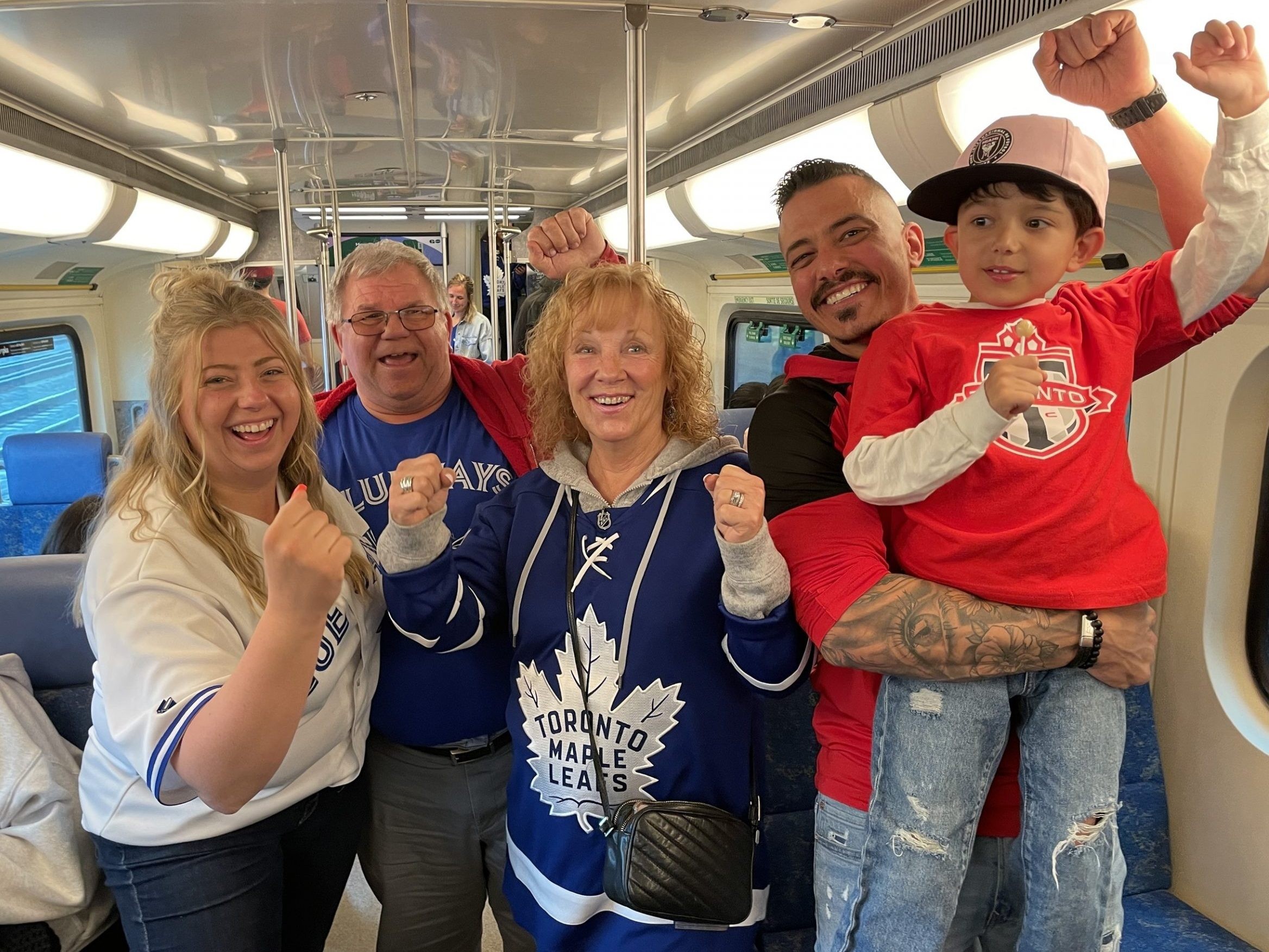 Toronto sports fans ride a GO Train.
