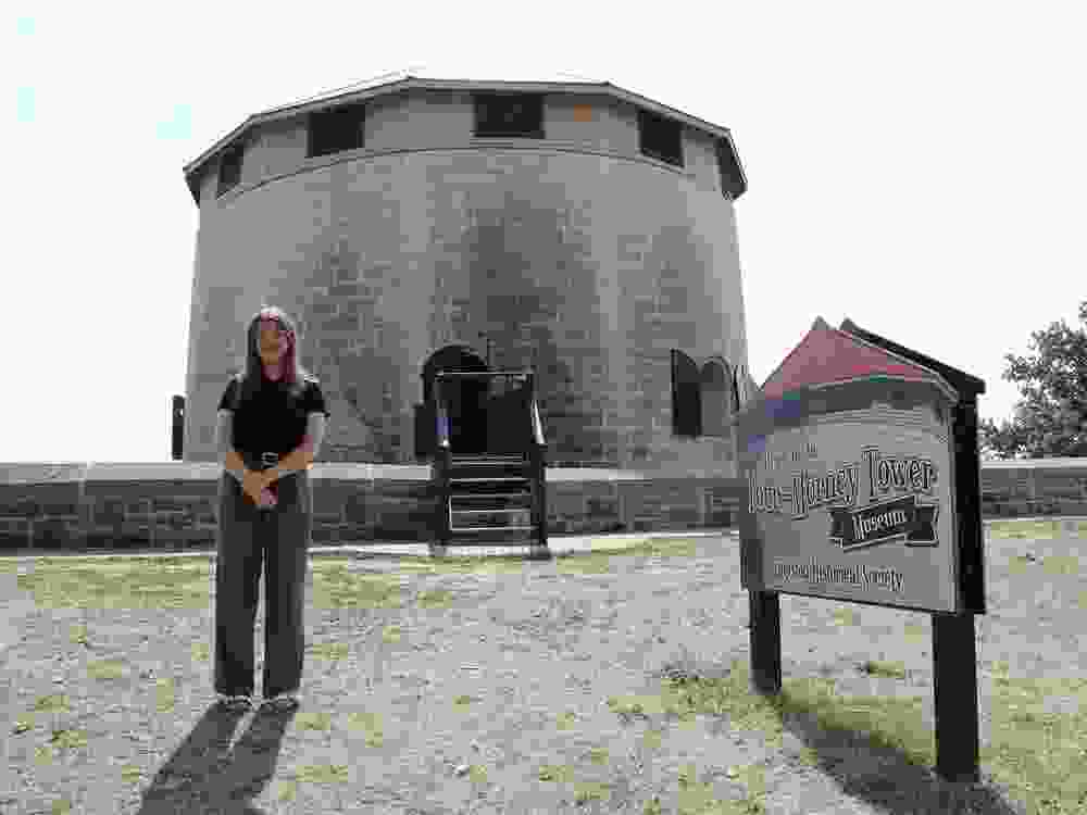 Alison Dringenberg stands in front of the Murney Tower Museum. This year marked 100 years of it being open to the public as a museum.