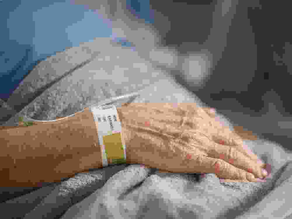 Elderly person in hospital bed