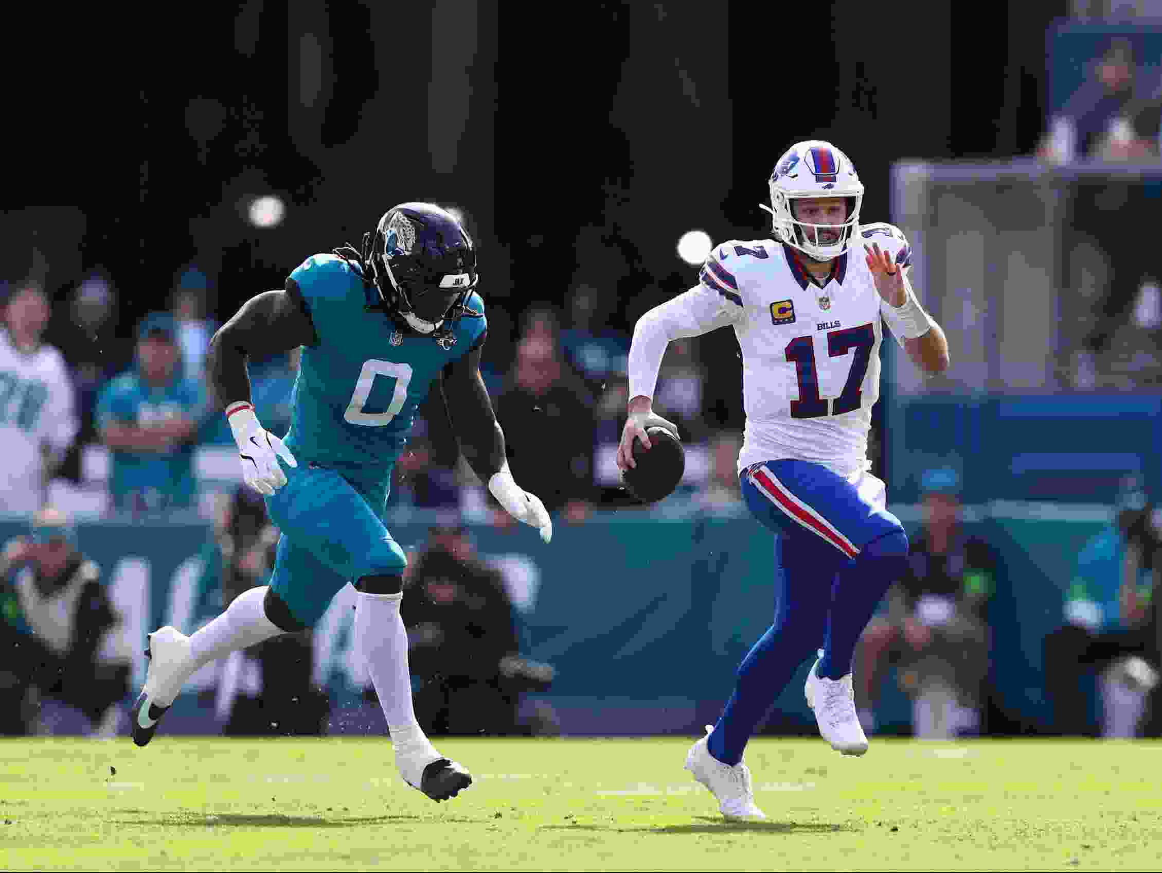 Josh Allen of the Buffalo Bills is pursued by Devin Lloyd of the Jacksonville Jaguars.