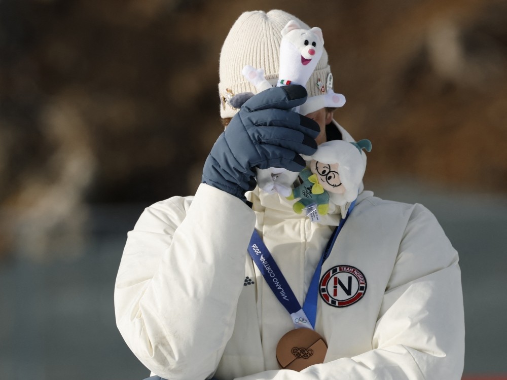 Bronze medallist Norway's Sturla Holm Laegreid reacts on the podium of the men's biathlon 20km individual event during the Milano Cortina 2026 Winter Olympic Games.