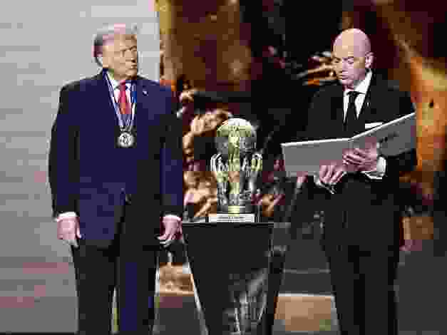U.S. President Donald Trump looks on as he receives the FIFA Peace Prize from FIFA President Gianni Infantino during the draw for the 2026 FIFA World Cup.