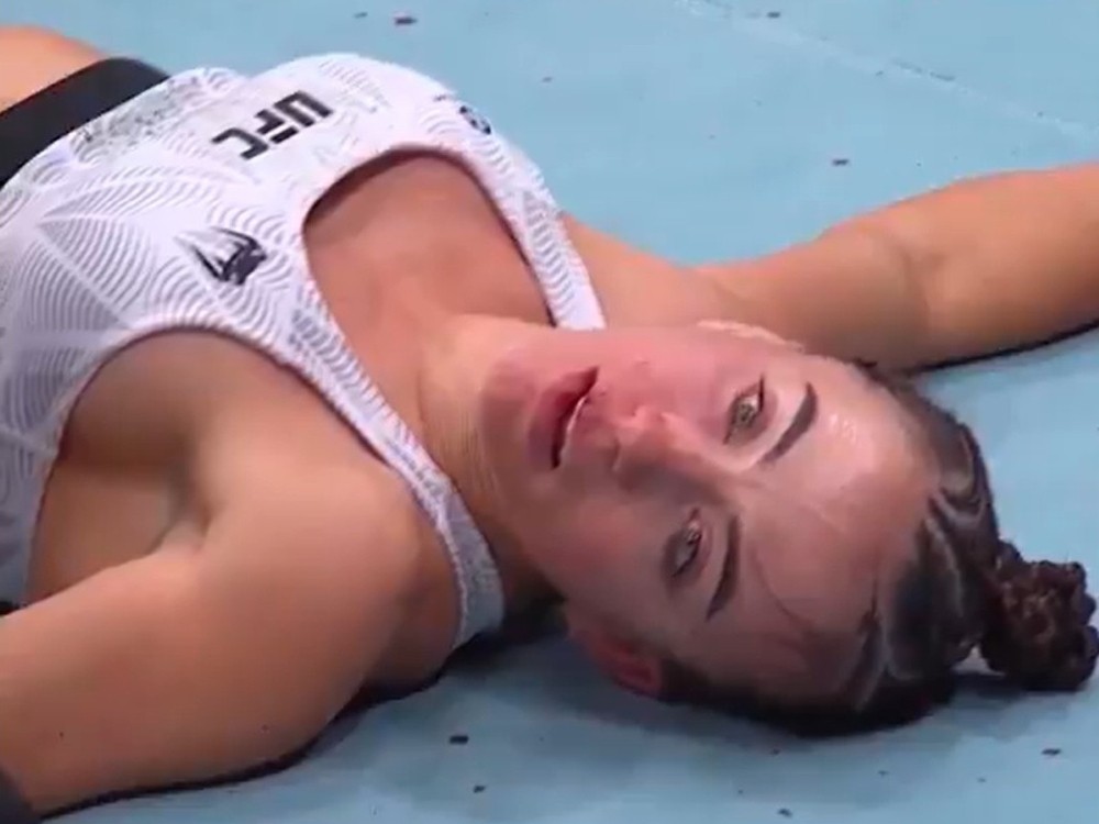UFC fighter Maycee Barber lies on the mat after her loss to Alexa Grasso.