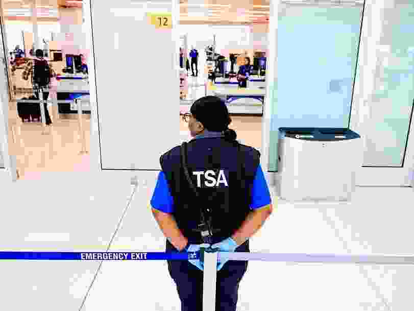 A TSA agent stands outside a security checkpoint at Denver International Airport on November 8, 2025 in Denver, Colorado.