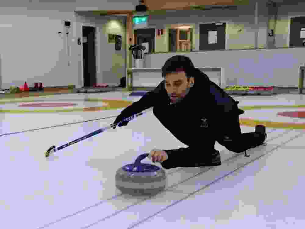 Swedish curler Oskar Eriksson demonstrates a double-touch.