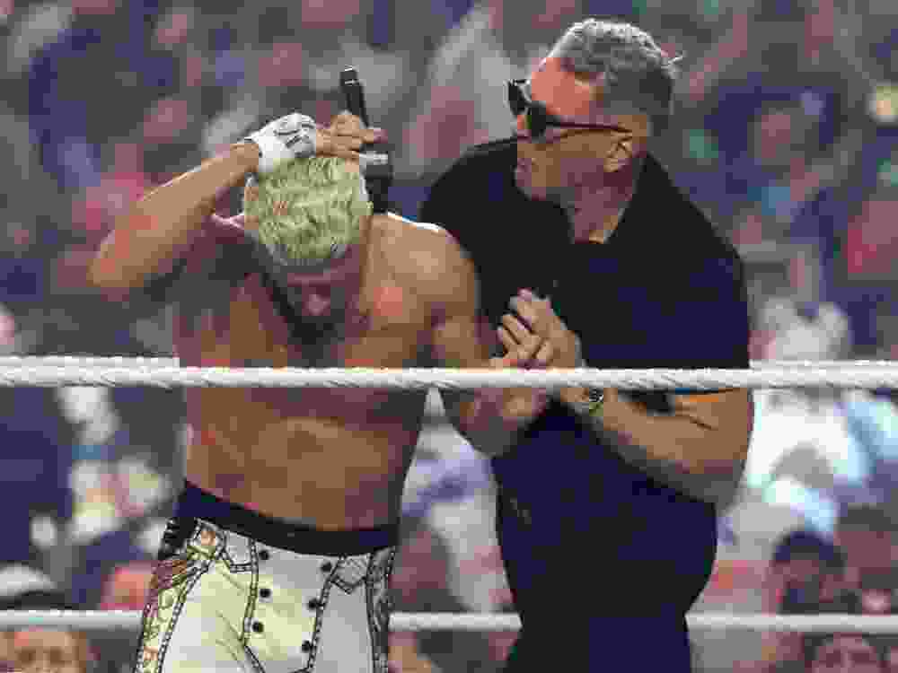 Pat McAfee attacks Cody Rhodes before the Undisputed WWE Championship match between Rhodes and Randy Orton during WrestleMania 42 at Allegiant Stadium.