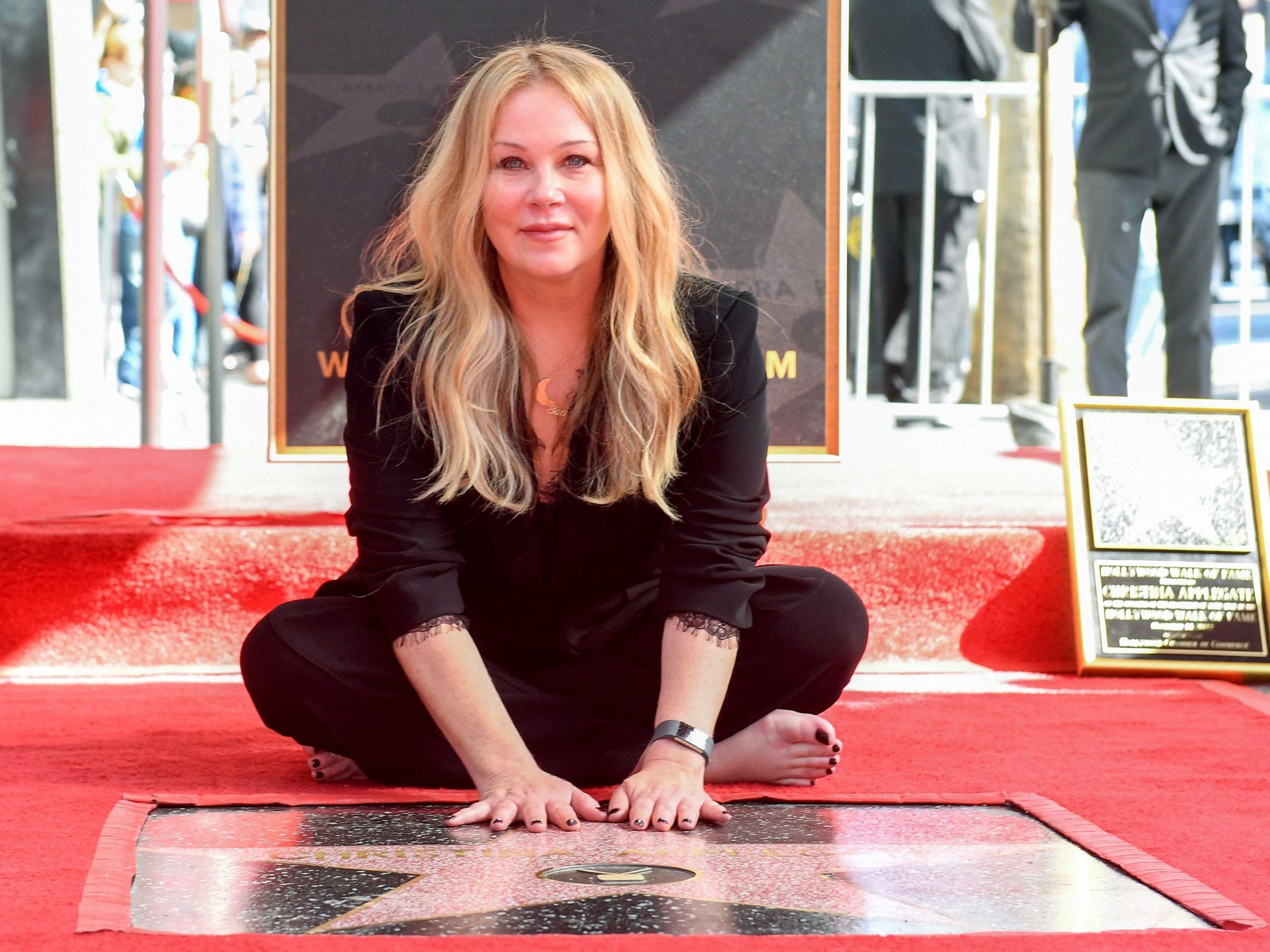 US actress Christina Applegate poses for photos with her newly unveiled Hollywood Walk of Fame star in Hollywood, California, on November 14, 2022.