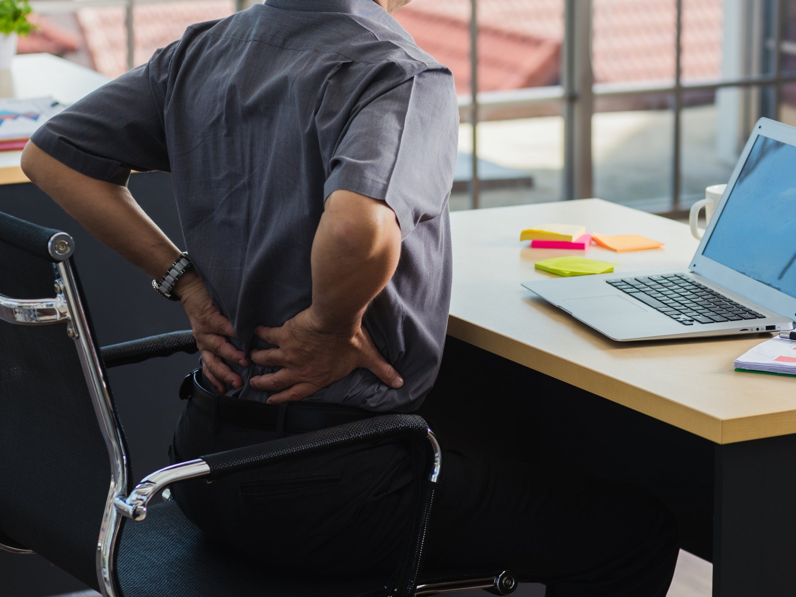 Asian hard senior businessman working with laptop computer has a problem with back pain. Old man feeling pain after sitting at desk long time, Healthcare and medicine office syndrome concept