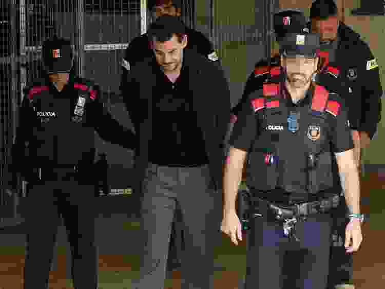 Catalan regional police officers (Mossos d'Esquadra) escort Jonathan Andic, the son of Isak Andic, founder of Spanish fashion brand Mango, as he arrives at a court in Martorell, near Barcelona, following his arrest on May 19, 2026.