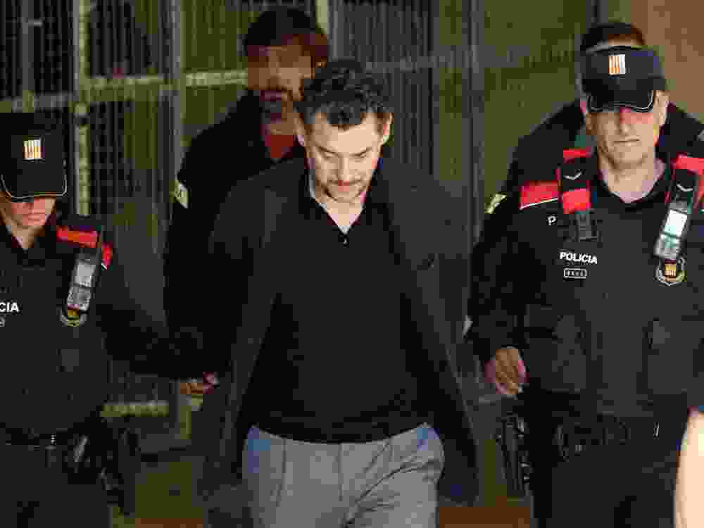 Catalan regional police officers (Mossos d'Esquadra) escort Jonathan Andic, the son of Isak Andic, founder of Spanish fashion brand Mango, as he arrives at a court in Martorell, near Barcelona, following his arrest on May 19, 2026.