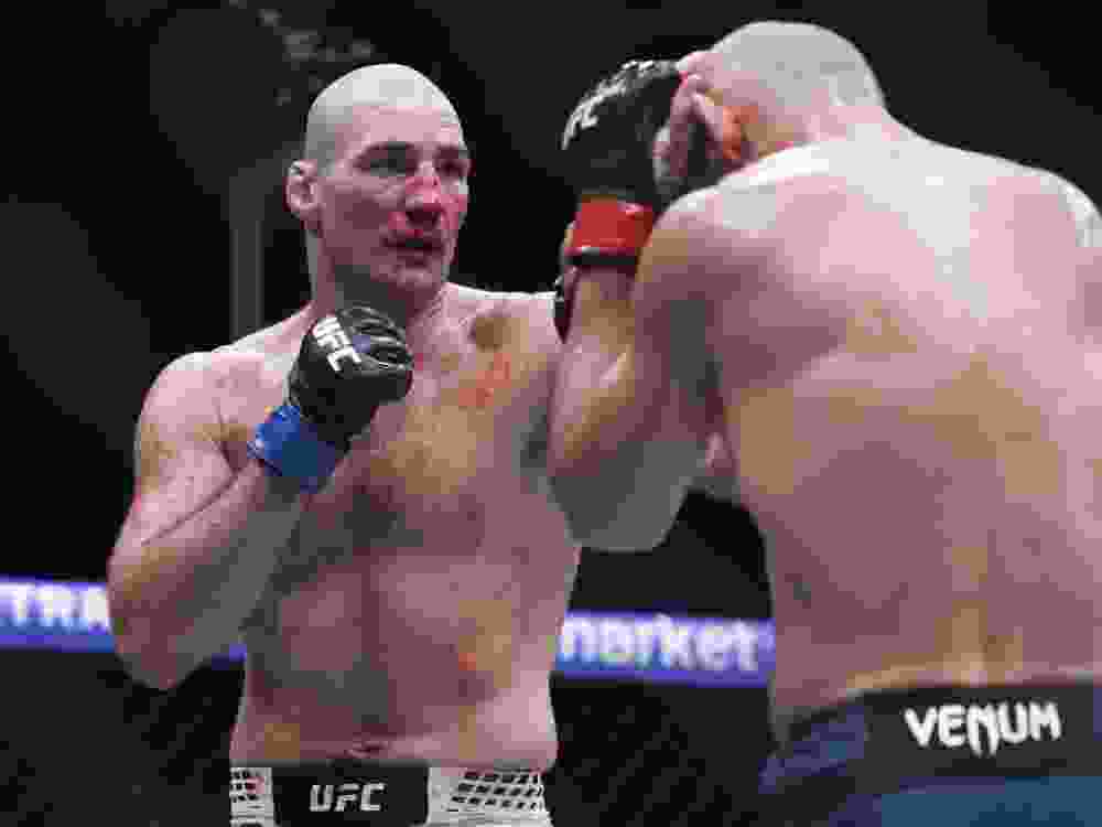 Sean Strickland fights Khamzat Chimaev in a middleweight title bout during UFC 328.