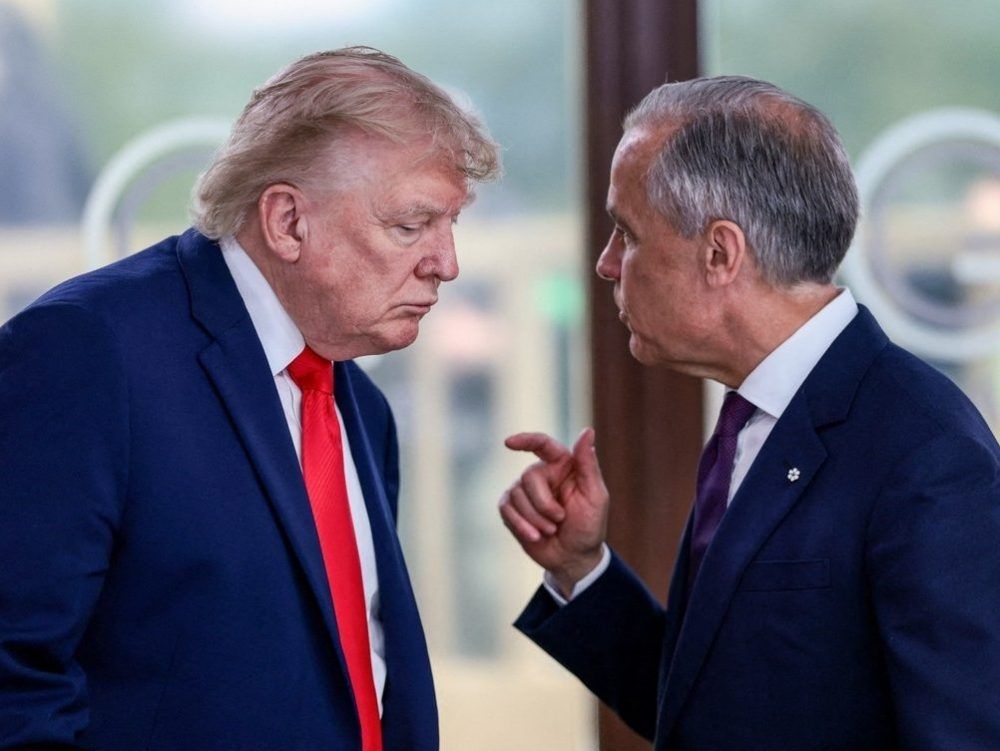 U.S. President Donald Trump speaks with Canada's Prime Minister Mark Carney during a work lunch as part of the G7 summit, in Evian, France, on June 16, 2026.