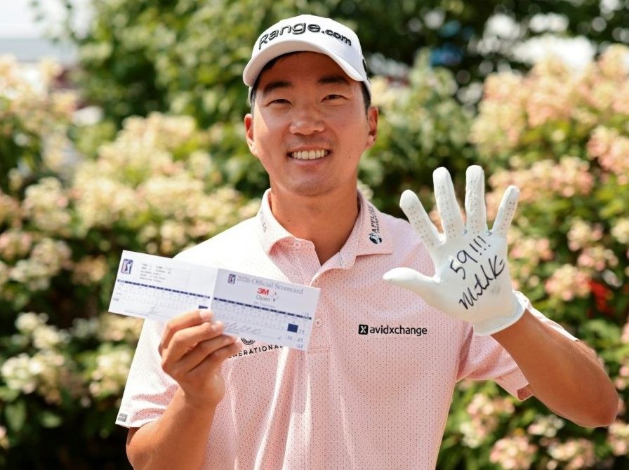 Michael Kim of the United States poses with his scorecard after shooting a 59 in the 3M Open in Minnesota.