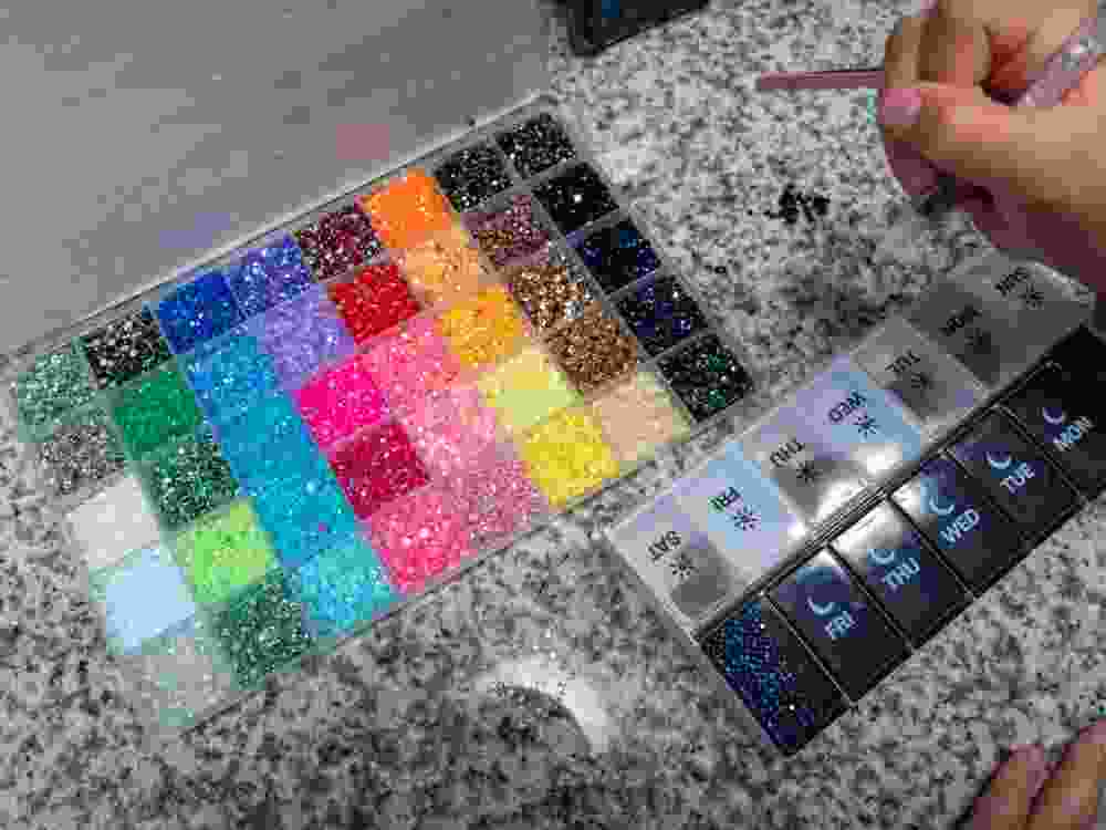Close-up of children’s hands applying rhinestones in a bedazzling craft activity. Creative DIY hobby for kids, focused on decoration, imagination, and learning through playful art