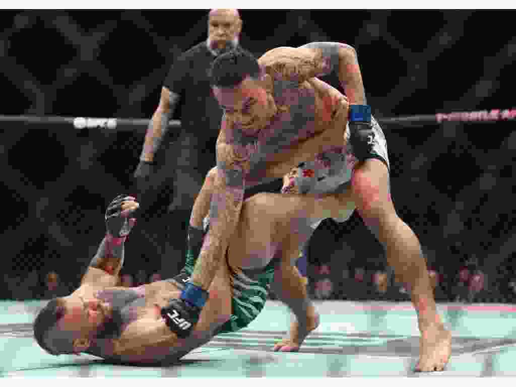 Max Holloway lands a punch on Conor McGregor