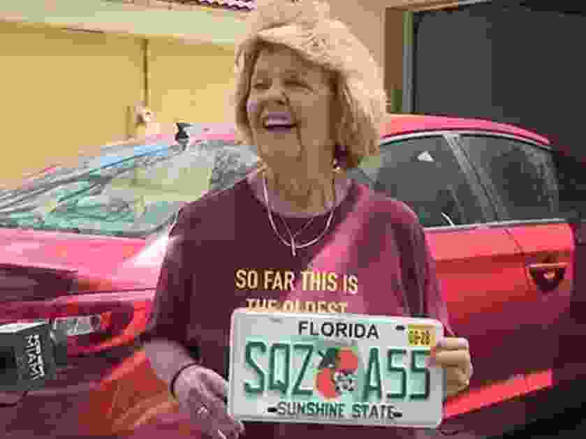 Nancy Dello Stritto, 76, holding up her wild new license plate.