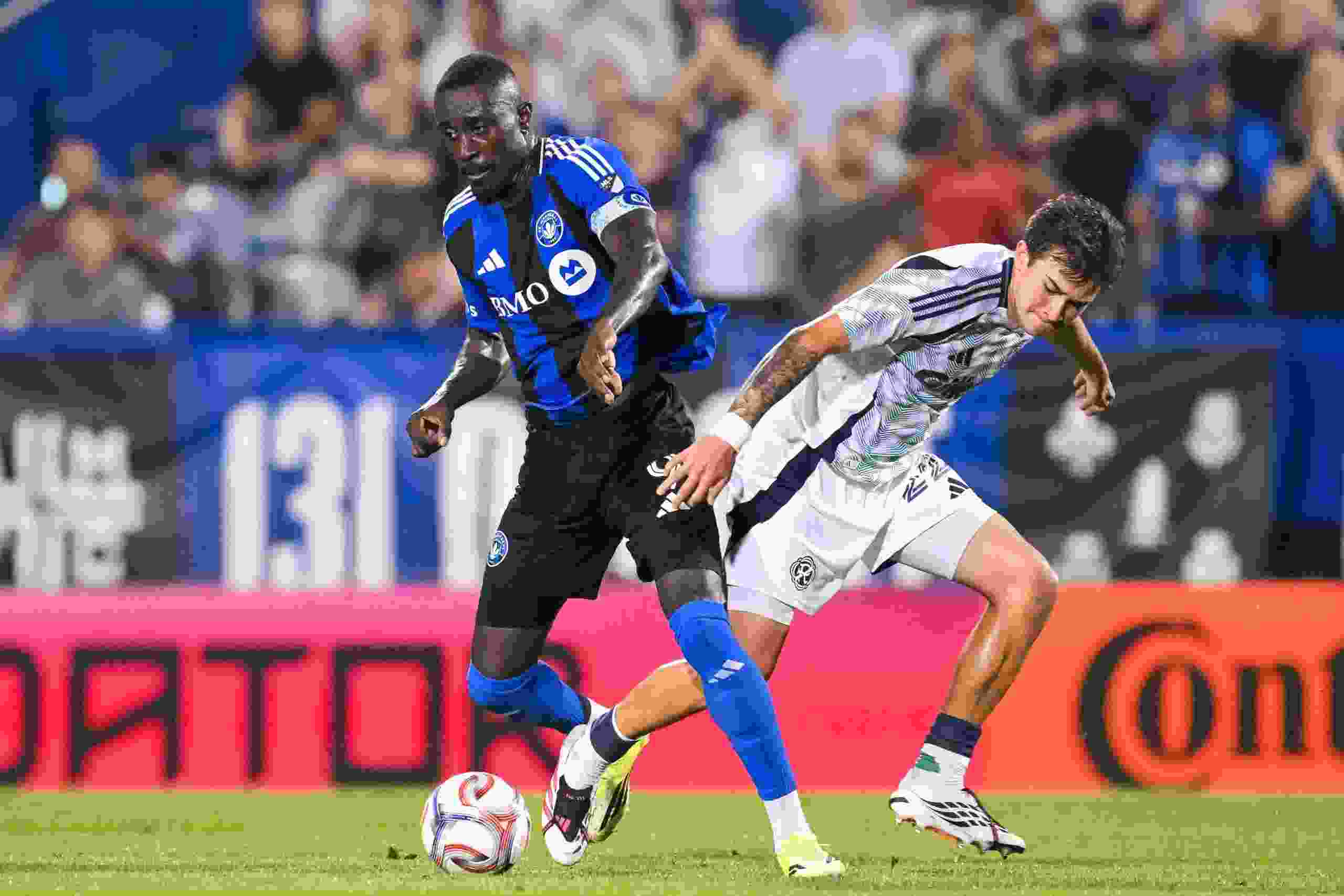 Prince Owusu of CF Montréal controls the ball against Ethan Kohler of the New England Revolution during the second half at Saputo Stadium in Montreal on Saturday, August 1, 2026.