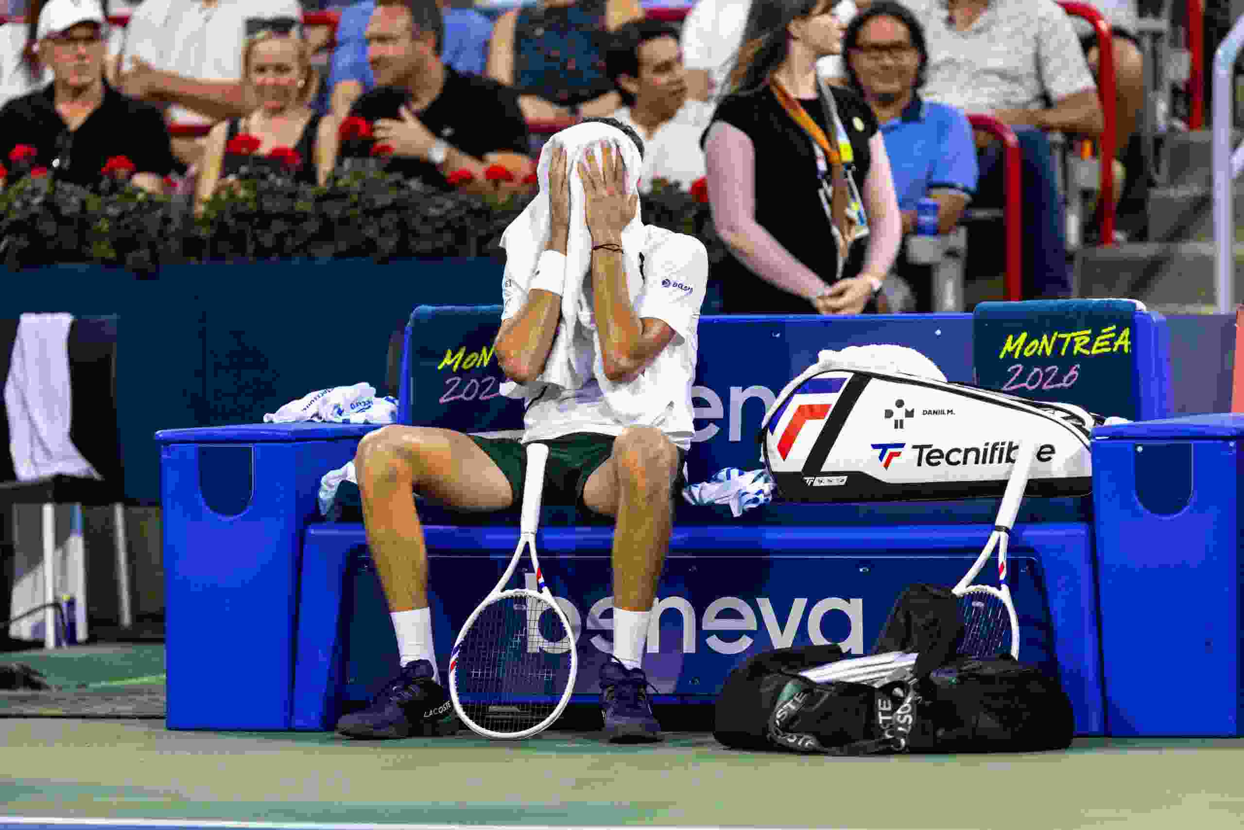 Daniil Medvedev wipes his face between sets against Botic van de Zandschulp during a second-round match at the National Bank Open in Montreal on Wednesday. Medvedev, the tourney's No. 4 seed, lost in straight sets.