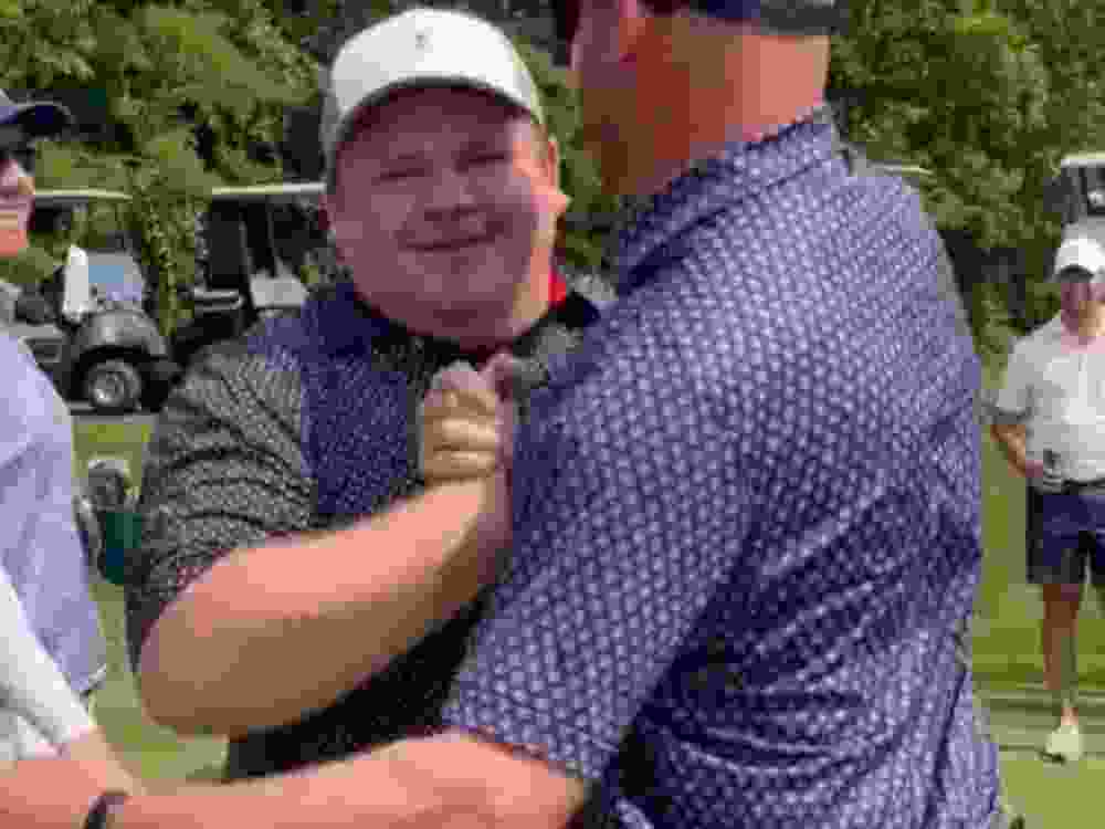 Amateur golfer Zach Holland celebrates after sinking a putt.