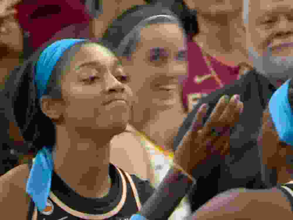 Indiana Fever's Caitlin Clark (right) and Atlanta Dream's Angel Reese react during a WNBA game on Sunday.