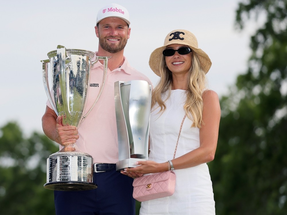 Wyndham Clark and girlfriend Emily Tanner pose with the winner's trophy and J.K. Wadley trophy after winning the BMW Championship.