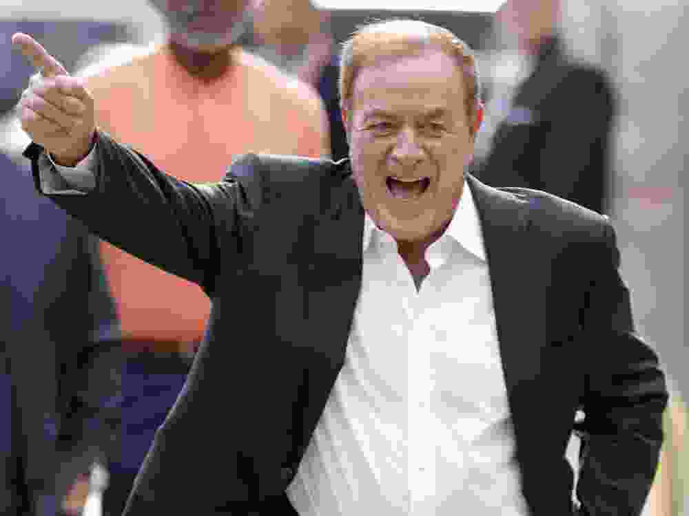 NFL broadcaster Al Michaels laughs as he walks into Arrowhead Stadium prior to the game between the Los Angeles Chargers and Kansas City Chiefs in 2022.