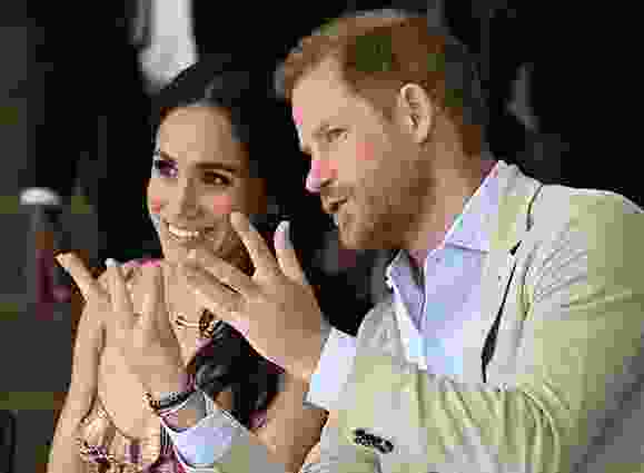 Prince Harry speaks with his wife Meghan Markle while attending a show during a visit to the National Centre for the Arts in Bogota on Aug. 15, 2024. Prince Harry and his wife Meghan, who cut ties with the British royal family in 2020, moved back to the United Kingdom last month.