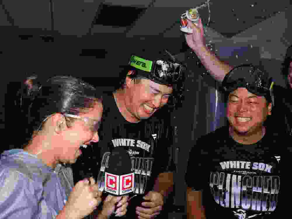 Munetaka Murakami (centre) of Chicago White Sox celebrates clinching the playoffs alongside interpreter Kenzo Yagi.