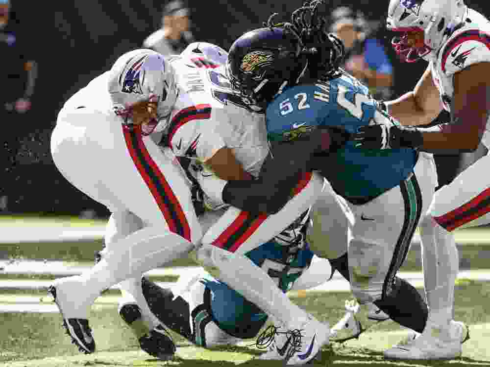 Drake Maye of the New England Patriots is tackled during a Week 3 game against the Jacksonville Jaguars.