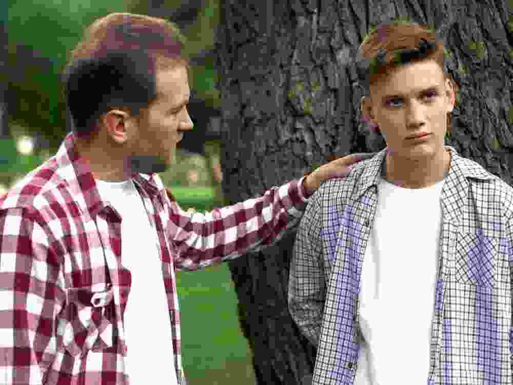 A father tries to talk to his son.