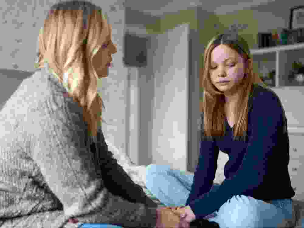 Mother having a conversation with her teenage daughter.