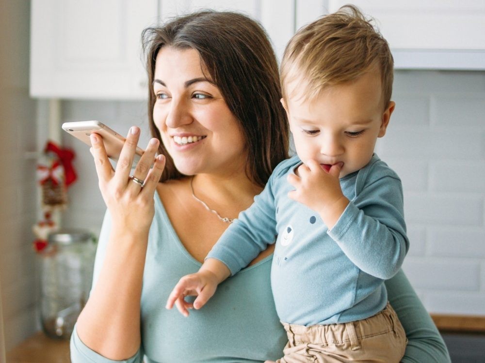 A young mother talks to her mother on a atelephone.