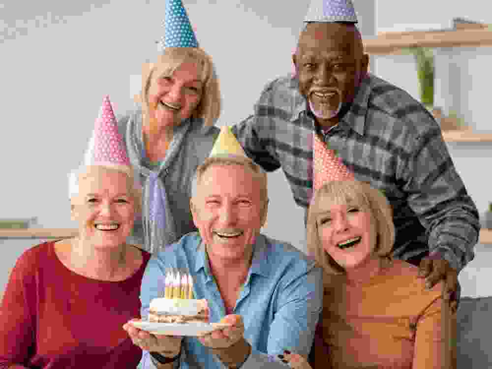 A group of adults celebrate birthdays.