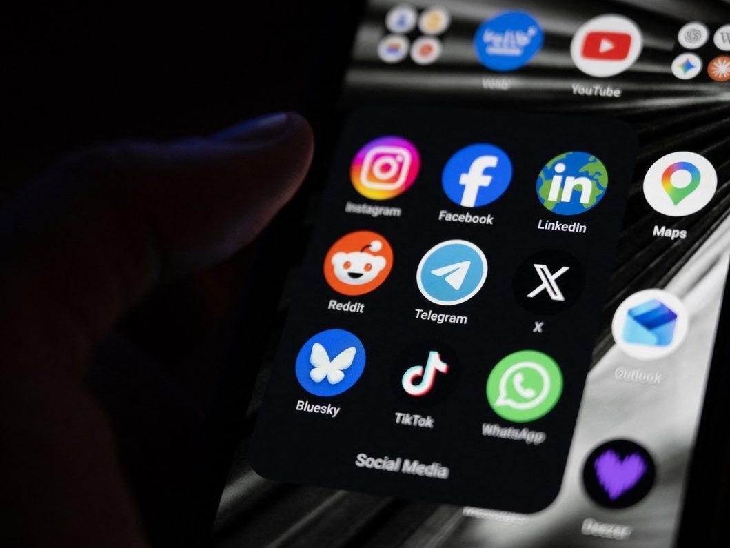 (FILES) This photograph shows a set up smart-phone screen displaying the logo of main social media platforms including Instagram, Facebook, LinkedIn, Reddit, Telegram, X, Bluesky, Tiktok and Whatsapp