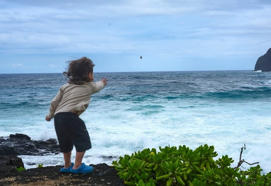 A child throws a rock toward the ocean at Makapu'u Beach Park in Honolulu, Hawaii, on September 6, 2026. Hawaii is preparing for the effects of Hurricane Lowell, which could brush by the state's westernmost islands from the evening of September 7, even as its exact path remains unclear. The storm was passing south of the island chain on September 4 but is set to swing north over the US Labor Day long weekend, possibly putting Kauai and Niihau islands near its centre, according to the latest forecast from the National Hurricane Center (NHC).