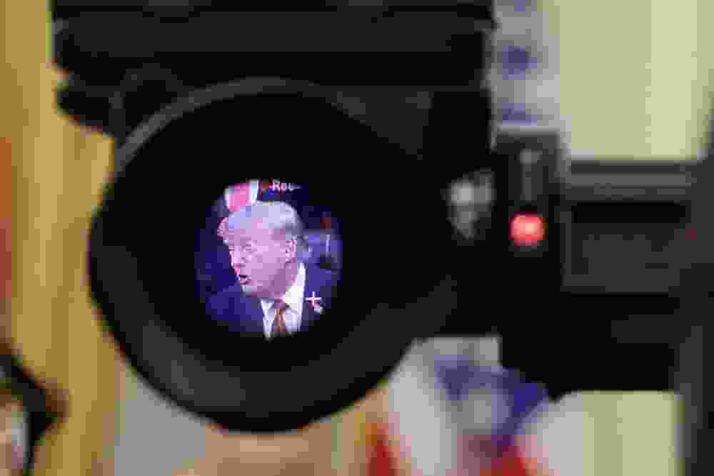 U.S. President Donald Trump is seen in the electronic viewfinder of a television camera as he speaks to reporters.