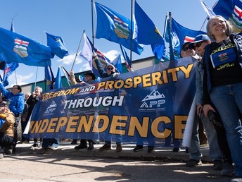 Separatist supporters gather during a rally in front of the Elections Alberta headquarters in Edmonton, Canada, on May 4, 2026, as they submit boxes of signatures in the hope of triggering an independence referendum. Alberta separatists submitted stacks of boxes to election officials on Monday, which they said contained the signatures of more than 300,000 supporters, enough names to force an independence referendum in Canada's oil-rich province. A boisterous crowd of several hundred waved the blue provincial flag on a bright, clear day, cheering as separatist leader Mitch Sylvestre delivered the petitions to Elections Alberta.