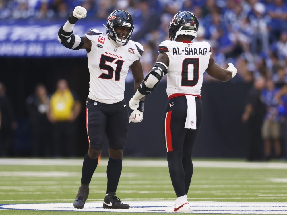 Will Anderson and Azeez Al-Shaair of the Houston Texans react after a forced turnover on downs against the Indianapolis Colts.
