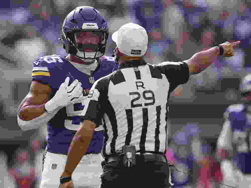 Minnesota Vikings linebacker Eric Wilson talks with referee Adrian Hill after an incident during Sunday’s game against the Miami Dolphins.